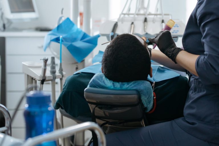 A dentist examining a patient.